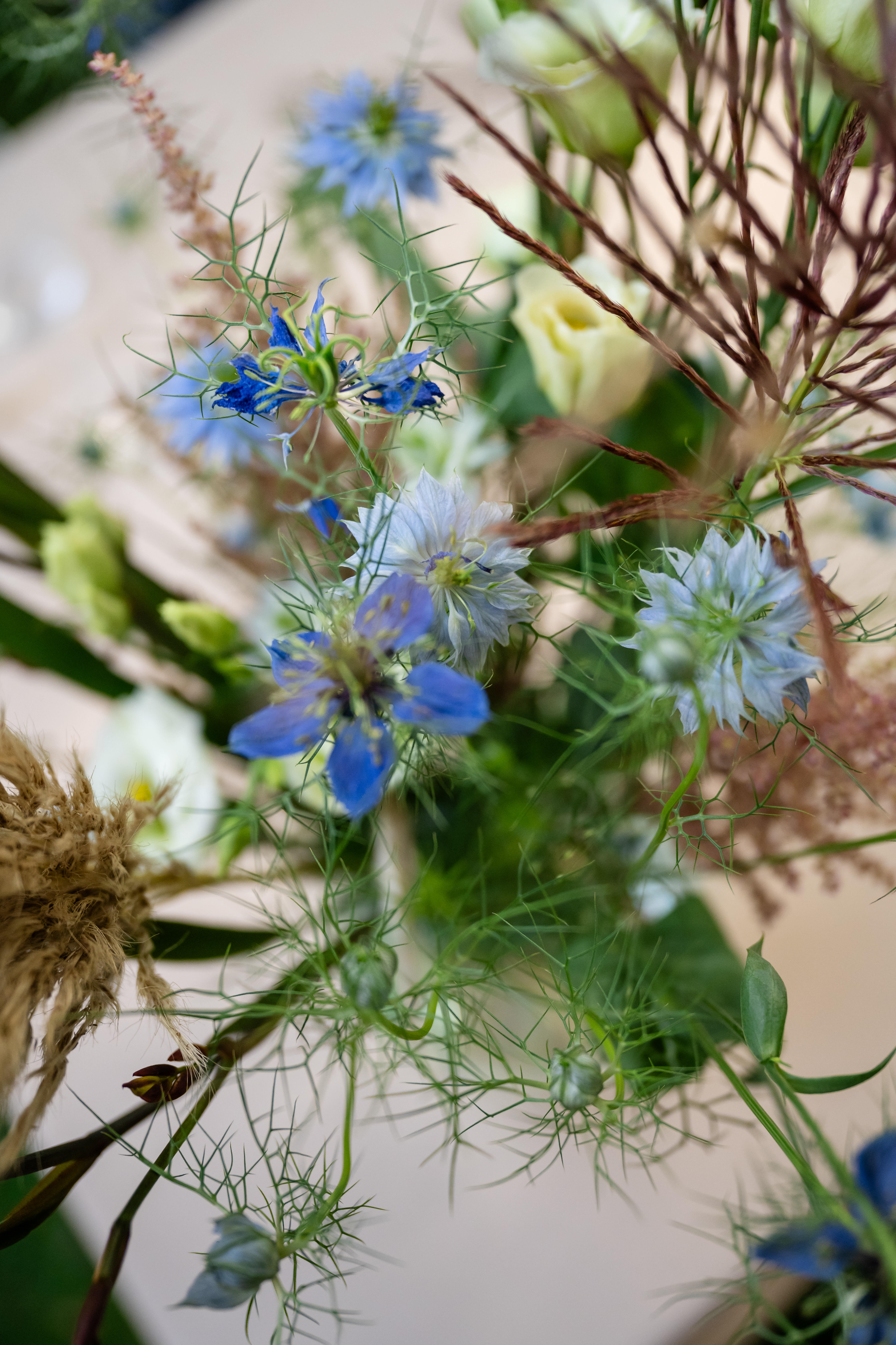 detail shot of bouquet of blue and tan flowers and details